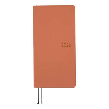 Orange notebook with '2026' printed on it against a white background