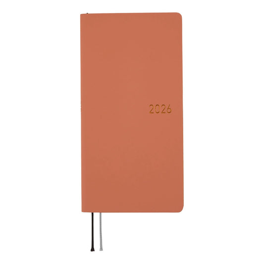 Orange notebook with '2026' printed on it against a white background