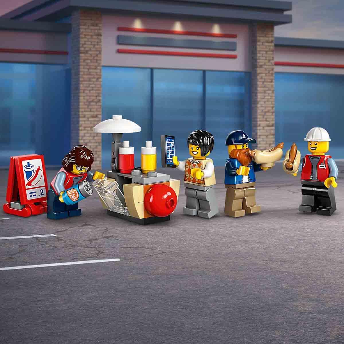 LEGO figurines at a gas station with a building in the background