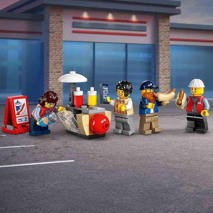 LEGO figurines at a gas station with a building in the background