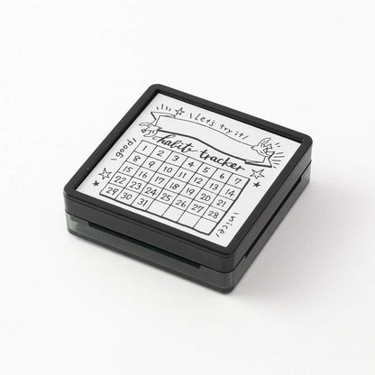 Small square dry erase board with a habit tracker on a white background