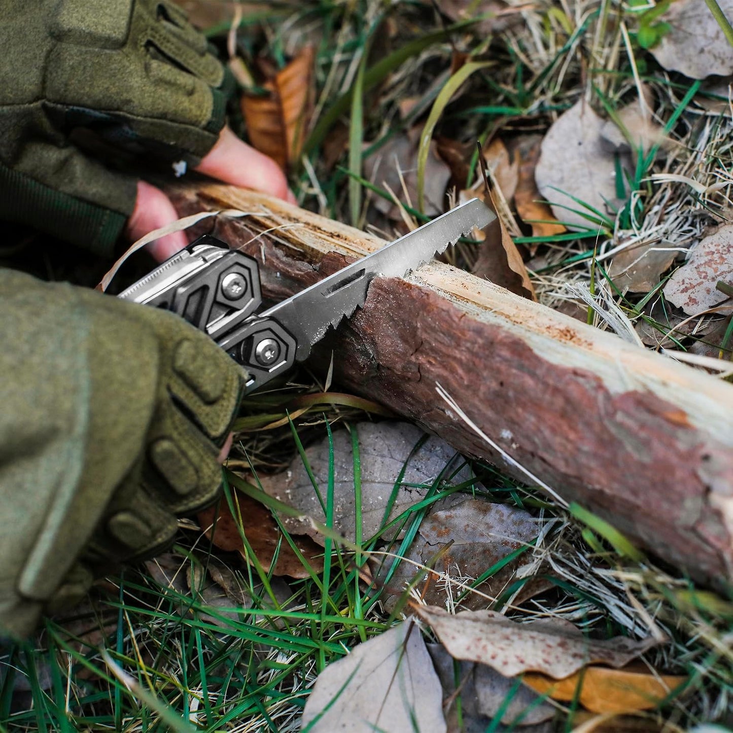 Person using a multi-tool to cut wood in a natural setting