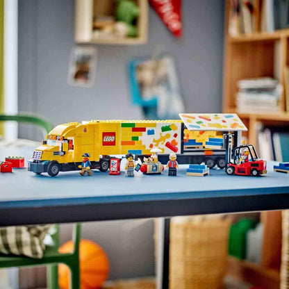 LEGO truck set on a table with various LEGO figures and items in a room setting.